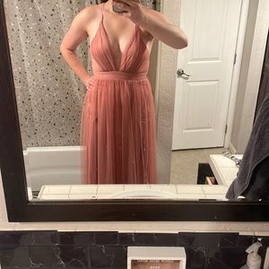 Small Pink tulle dress with deep v neckline, crossed back and high slits.